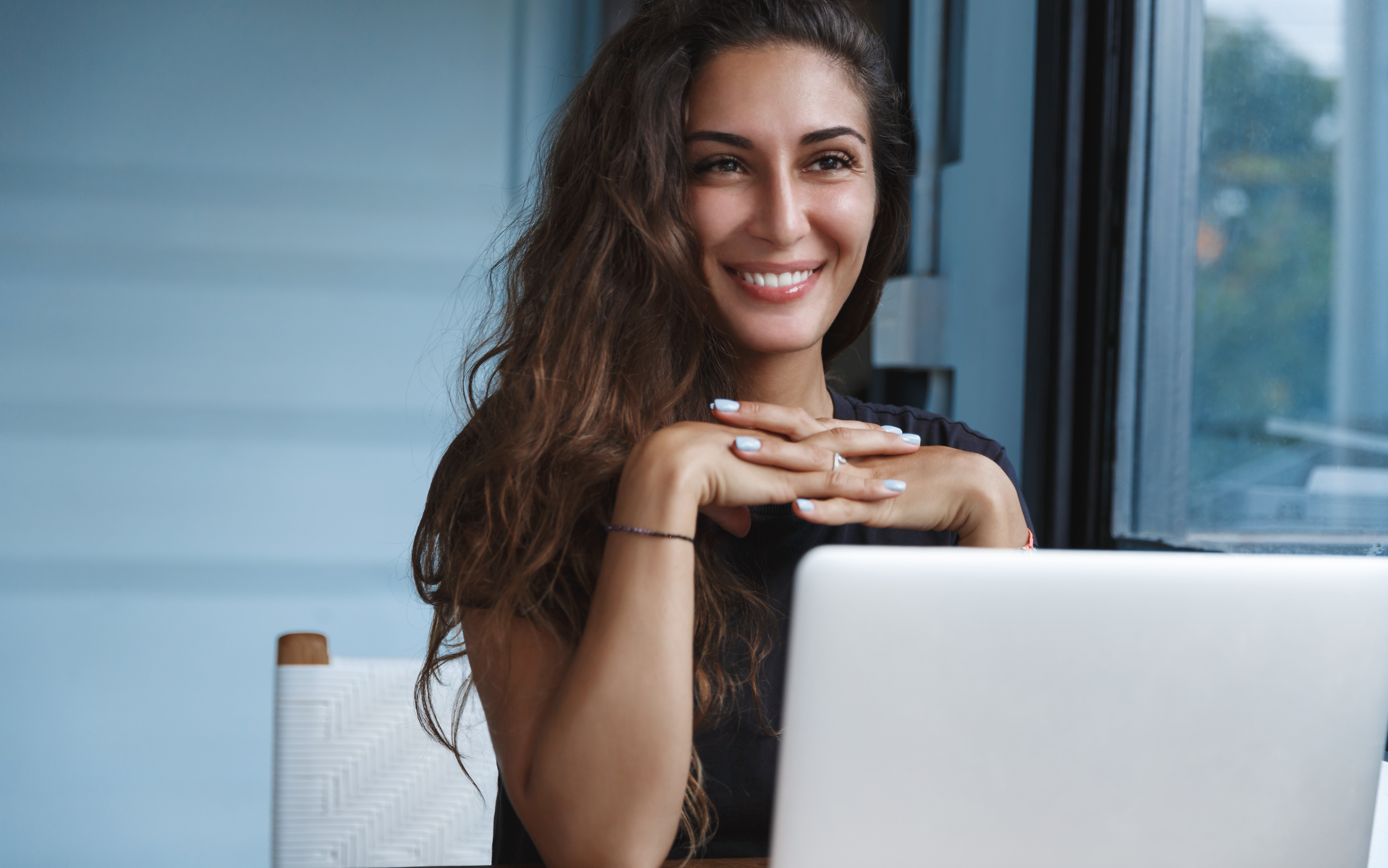 beautiful-young-woman-casual-clothing-using-laptop-smiling-while-working-indoors