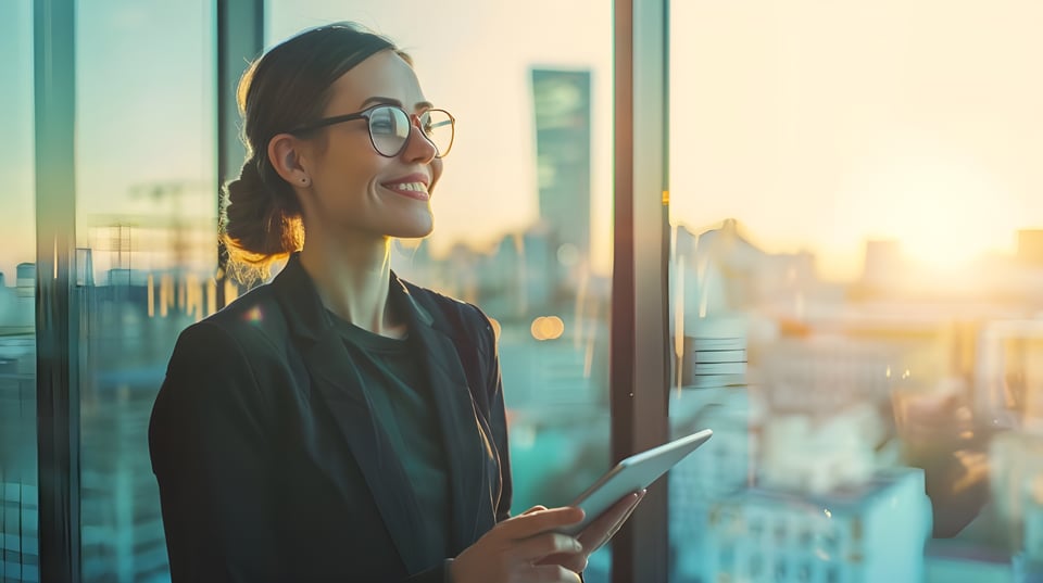 happy-confident-young-businesswoman-professional-holding-smart-tablet-looking-out-office-window